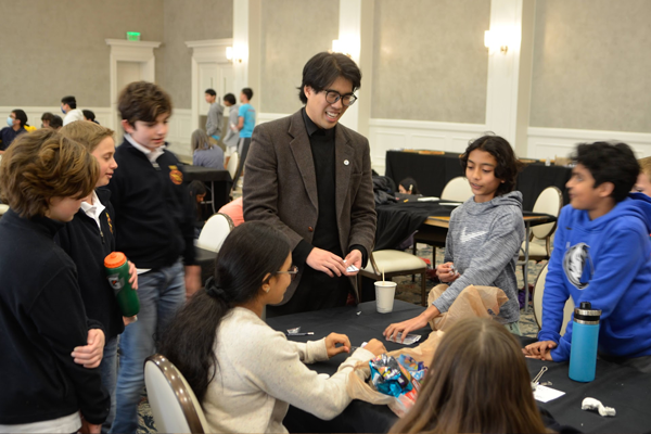 Image of TSPE Dallas volunteers and kids participating in the Texas Mathcounts Competition